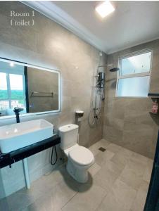 a bathroom with a toilet and a sink and a tub at Sandakan Ijm pool view condo in Sandakan