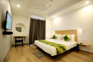 a hotel room with a bed and a television at Hotel Rudra Inn At Chattarpur in New Delhi