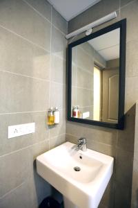a bathroom with a sink and a mirror at Hotel Rudra Inn At Chattarpur in New Delhi