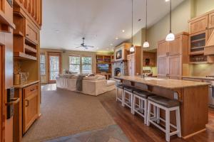 a kitchen with a large island with bar stools at Ski In Ski Out 1200sf VIP Palisades Condo Mountain Open Until Memorial Day in Olympic Valley