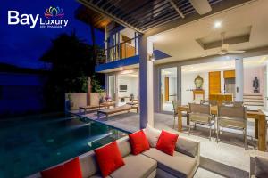 a living room and dining area of a villa at Luxury Asian Flair Villa in Koh Phangan
