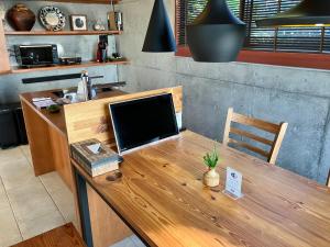 a wooden table with a computer on top of it at Kaiza in Nanjo