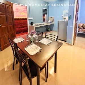 a dining room table with chairs and a dining room at 3-4paxs Sekinchan Dzulhomestasy Padi View Aircon in Kampong Batu Dua Puloh Tiga