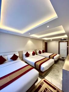 Postel nebo postele na pokoji v ubytování Hotel Prime Suite