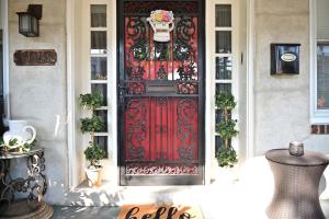 a red door with a flower basket on top at Garden Oasis in Historic Germantown, Philadelphia in Philadelphia