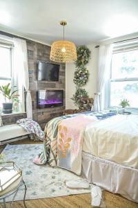 a bedroom with a bed and a tv on a wall at Garden Oasis in Historic Germantown, Philadelphia in Philadelphia