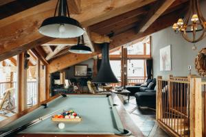 a living room with a pool table in it at Joubarbe Rose By Lodji in Saint-Martin-de-Belleville