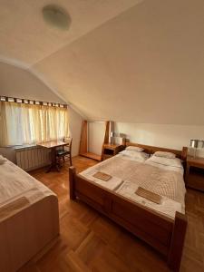 a large bedroom with two beds and a desk at VILLA M Rustic & Spa in Slatina Varoš +37 photos