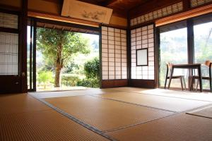 um quarto vazio com uma grande janela e uma mesa em すさのわ em Izumo