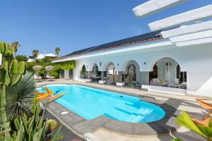 a swimming pool in the backyard of a house at Oasis de lujo - luxury boutique villa in Costa Teguise