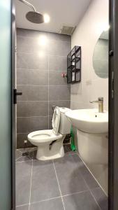 a bathroom with a toilet and a sink at Lucy House in Ho Chi Minh City