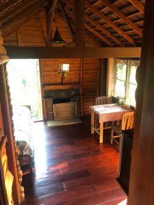a room with a table and a fireplace in a cabin at Yang Tone Farm Stay in Chiang Dao
