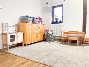 a living room with wooden furniture and a window at Chalupa Rozálka in Černý Dŭl