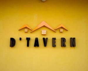 a sign that says doannis on a yellow wall at D'Tavern Apartment in Ibadan