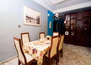 a dining room with a table and chairs at D'Tavern Apartment in Ibadan
