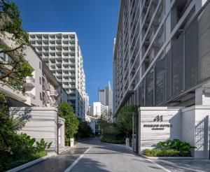 a street in a city with tall buildings at Maison Hotel Bangkok in Bangkok