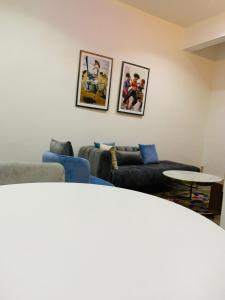 a living room with two couches and a table at Iyoba Apartment in Abuja