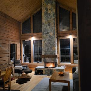 a living room with a stone fireplace in a house at Idre Mountain Lodge in Idre