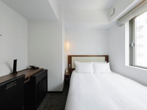 Postel nebo postele na pokoji v ubytování Tokyu Stay Shinjuku