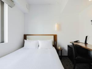 Postel nebo postele na pokoji v ubytování Tokyu Stay Shinjuku