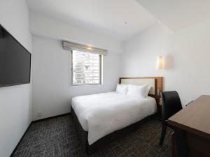 Postel nebo postele na pokoji v ubytování Tokyu Stay Shinjuku