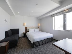 Postel nebo postele na pokoji v ubytování Tokyu Stay Shinjuku