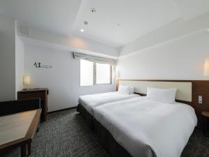 Postel nebo postele na pokoji v ubytování Tokyu Stay Shinjuku