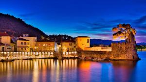 a town on the water at night at my own way in Nafpaktos