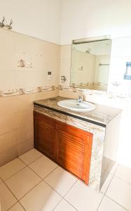 a bathroom with a sink and a mirror at Mount View Residencies in Colombo