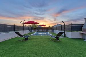 einen Hinterhof mit Pool, Stühlen und Sonnenschirm in der Unterkunft Villa Tri Palme with heated pool in Vrsi