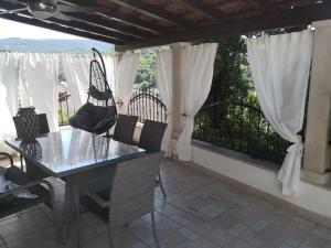 a dining room with a table and chairs and a window at apartman house Bjedov in Povlja