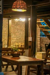 a wooden table with a potted plant on top of it at HÀ GIANG WOODEN HOUSE in Ha Giang