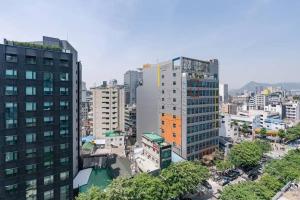 an overhead view of a city with tall buildings at NEST Myeongdong Residence high-rise floor #Namsan #Hanok village #Gyeongbok palace #Euljiro in Seoul