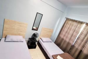 a bedroom with two beds and a mirror and a window at CH Homestay Tanah Rata, Cameron Highlands, Keyless Entry in Tanah Rata