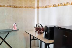 a table with a coffee maker on top of it at CH Homestay Tanah Rata, Cameron Highlands, Keyless Entry in Tanah Rata +6 photos