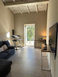 a living room with a couch and a table at MP Luxury House in Budoni