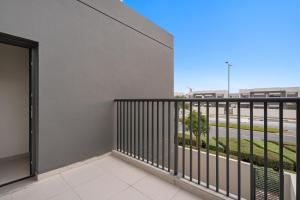 a balcony with a view of a street at Lovely 3BR Villa in Dubai EXPO in Dubai