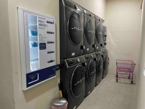 a row of washers and dryers in a laundry room at NEST Myeongdong Residence high floor #Namsan #Hanok village #Gyeongbok palace #Euljiro in Seoul