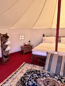 a bedroom with a bed in a tent at Desert waves camp in Bidiyah