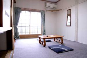 a room with a table and a large window at ロッヂとんや in Seki