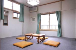 a room with a table and some windows at ロッヂとんや in Seki