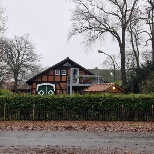 a house with a balcony in front of it at Bei Conny und Bernd in Barnstorf