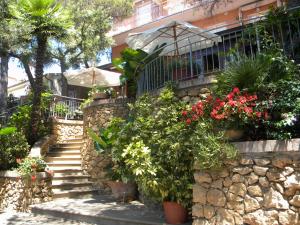 a stairway with flowers and plants in front of a building at Hotel Rosa Del Tirreno in Quercianella