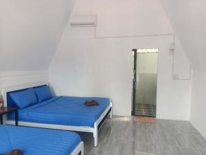 a room with two beds and a walk in shower at Blue Zone Hostel in Kaôh Rŭng (3)