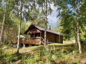 a large wooden house in the middle of a forest at Villa Nurminiemi in Koro
