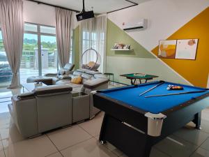 a living room with a pool table in it at Paradise Villa Kempas Utama in Skudai