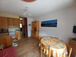 a kitchen and dining room with a table in a room at Appartement au Sommand au pied des pistes in Mieussy