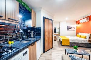 a room with a kitchen and a bedroom with a bed at Terra Rossa in Antalya