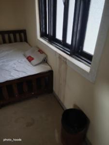 a small bedroom with a bed and a window at Hotel Saroj Sagar Madhya Pradesh in Sāgar