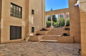 a large building with stairs and a building at Luxurious cozy apartment in Amman